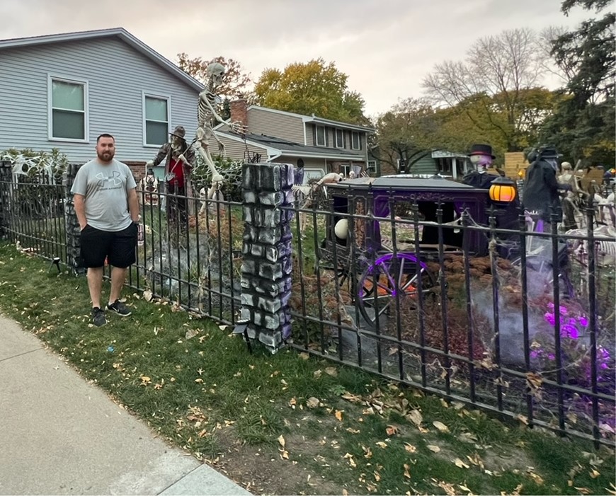 Derek Schmidt in front of his house adorned with Halloween spirit.