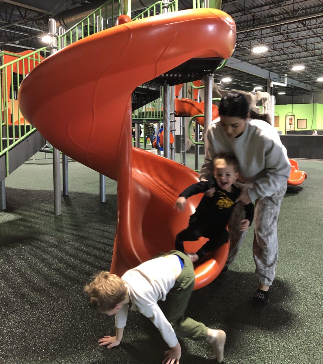 A mother and her two sons play at the Good Times Park at 7805 Hudson Rd. when it opened yesterday.