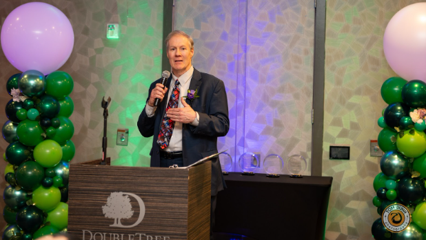 Woodbury City Administrator Clint Gridley addresses the crowd at Woodbury Area Chamber of Commerce 2025 Gala after receiving the organization’s Lifetime Achievement Award.