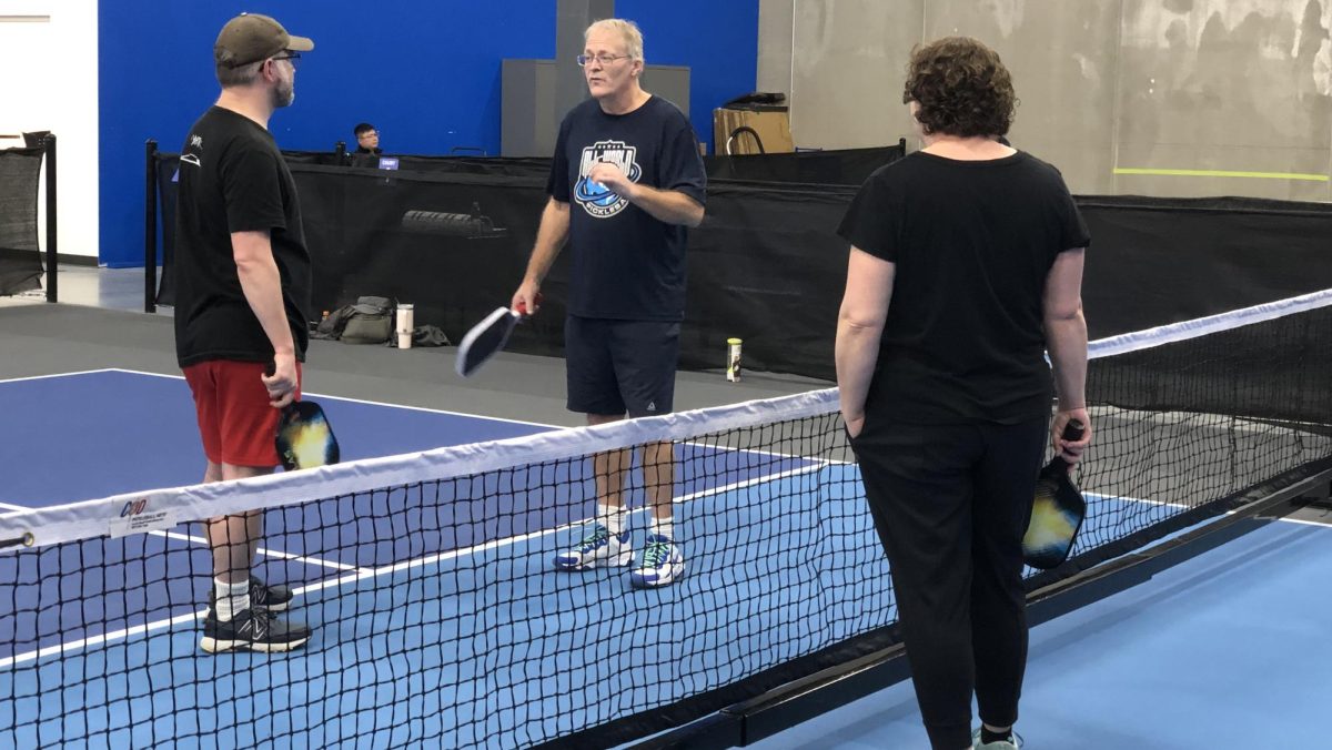 Edin gives a lesson to two newcomers at All World Pickleball
