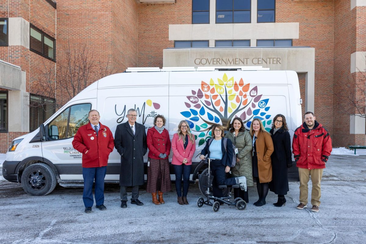 Washington County Commissioners Stan Karwoski (District 2), Fran Miron (District 1), Bethany Cox (District 3), Michelle Clasen (District 5), and Karla Bigham (District 4) stand with staff from the Community Services Department in front of the Washington County Mobile Social Services Vehicle. Photo: Washington County