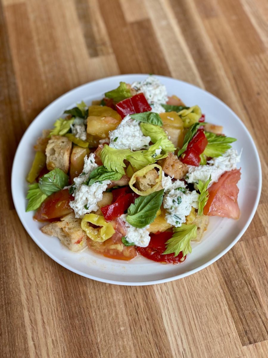 Panzanella with marinated crab, heirloom tomatoes, and crispy Tuscan croutons, finished with torn basil and celery leaves.