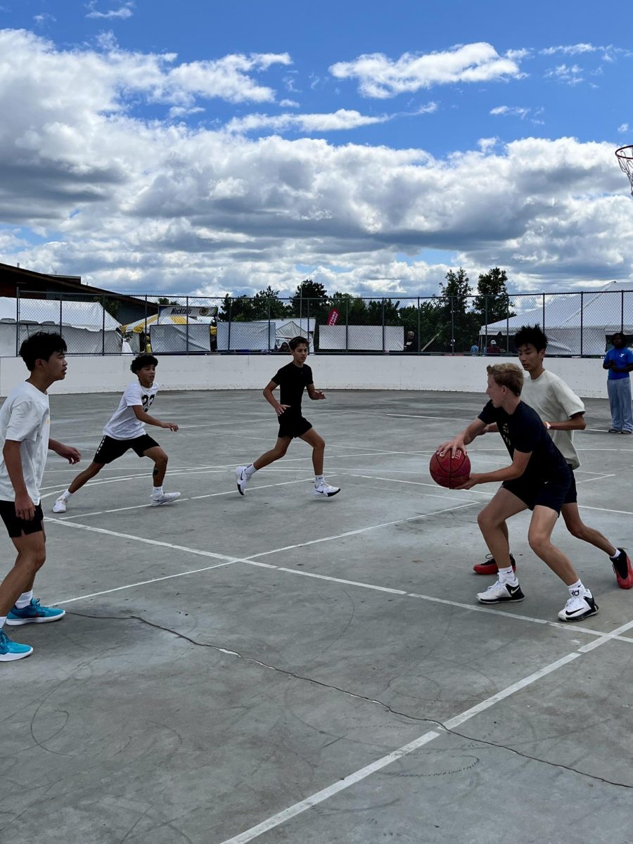 Players competed in a 3-on-3 basketball game at Woodbury Days in Woodbury, Minn., as a ballhandler set in a triple-threat position. The YMCA of the North tournament featured girls and boys brackets, ran from noon to 3:30 p.m. Sunday, Aug. 24, and awarded each winning team member two tickets to a future Minnesota Timberwolves game.