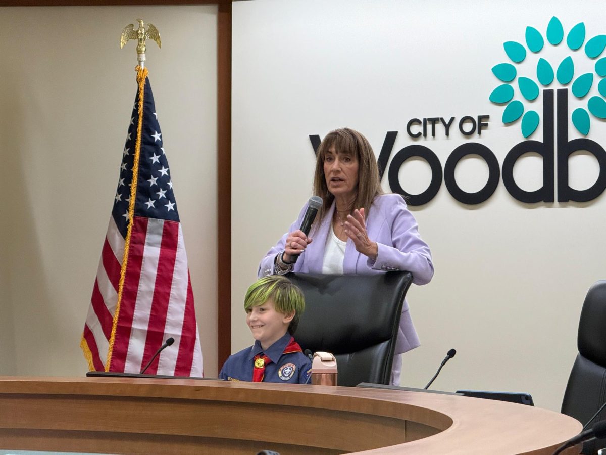 Felix Johnson and Mayor Anne Burt speaking at the Woodbury City Council meeting on April 8, 2026.