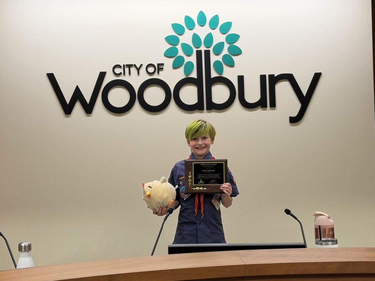 Fourth grader Felix Johnson, Woodbury's Mayor or the Day contest winner, with Bill the Chicken on April 8, 2026. (Credit/City of Woodbury)