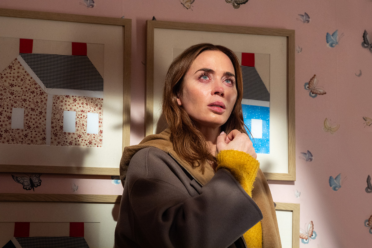 A woman stands agains the wall in a child's bedroom